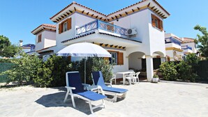 A two-story building with a balcony, white walls, and a tiled roof. - VM 6 - Duplex with private garden near the beach (Vera playa)