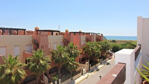 A coastal building with balconies, palm trees, and a clear view of the sea. - Al 317 - Penthouse near the beach with terrace (Vera playa)