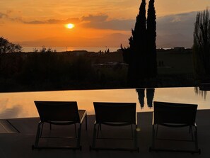 Outdoor pool, an infinity pool, pool loungers