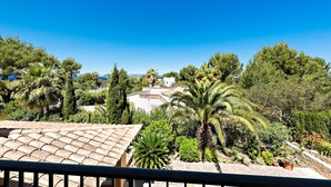 A terrace with a tiled roof, surrounded by lush greenery and palm trees. - Fantastic villa with pool in Betlem (Arta Betlem)