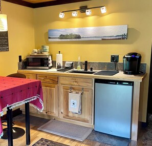 Fridge, microwave, coffee/tea maker, cookware/dishes/utensils