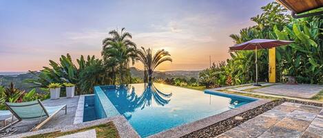 Een buitenzwembad en een infinitypool