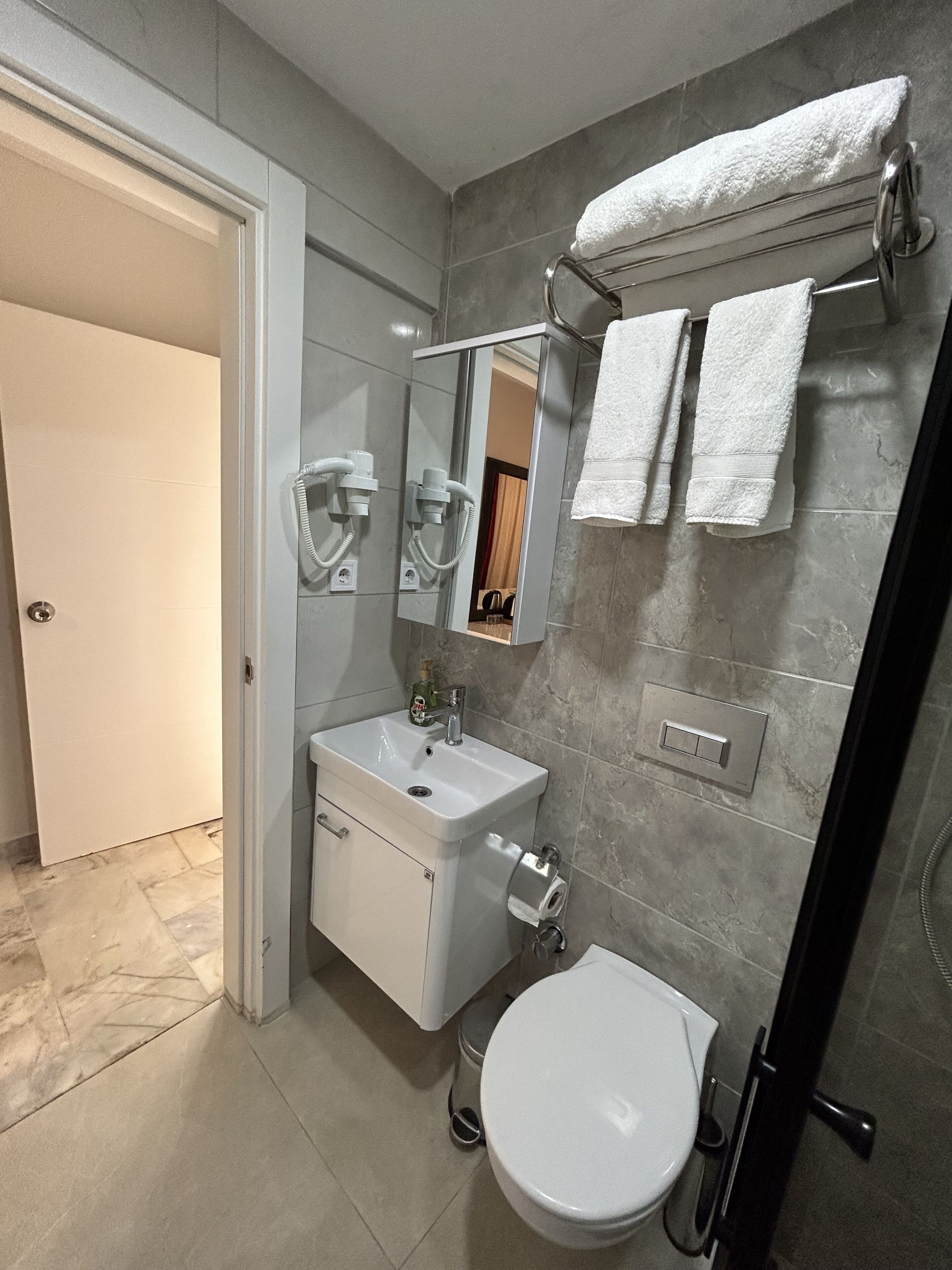 standard twin room | bathroom | shower, hair dryer, towels