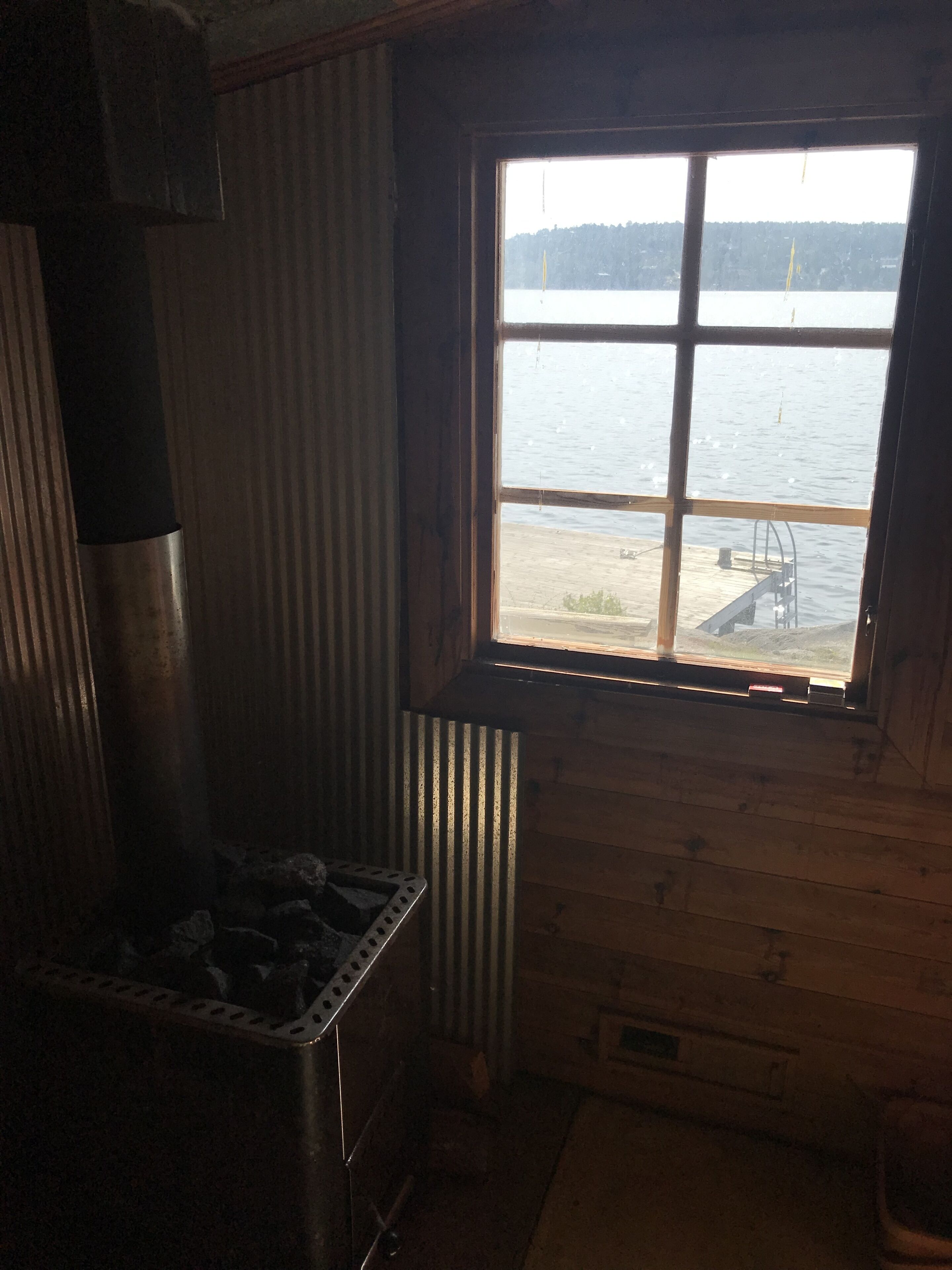 A small kitchen with a window overlooking a body of water.
