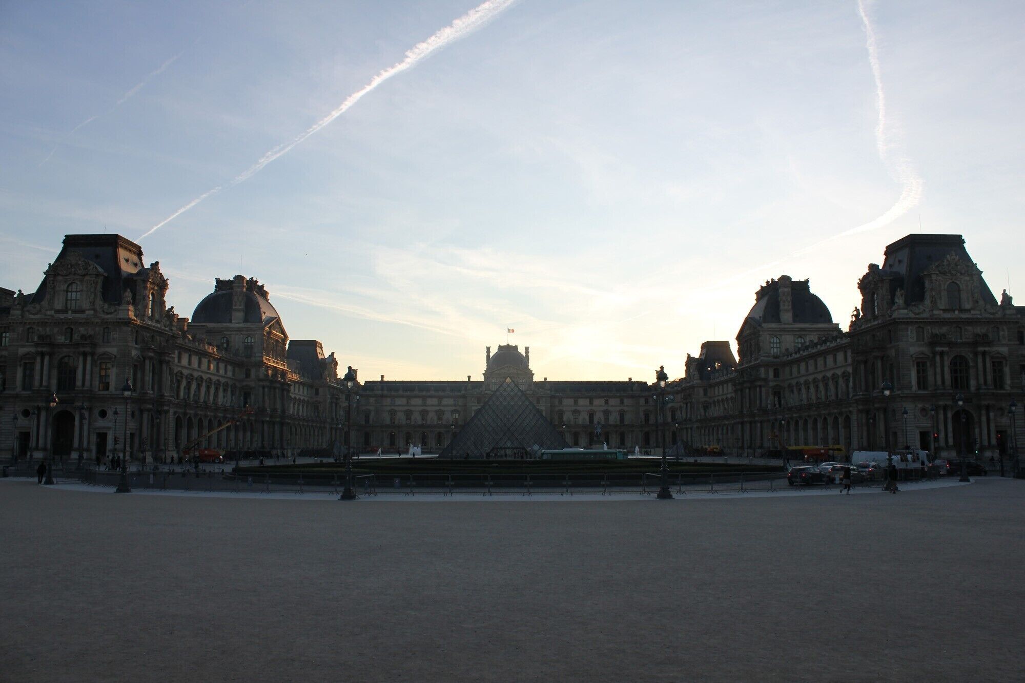 A large, historic building with symmetrical architecture and a central courtyard.