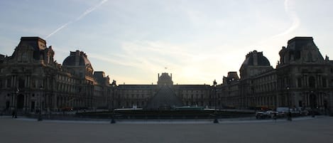 A large, historic building with symmetrical architecture and a central courtyard.