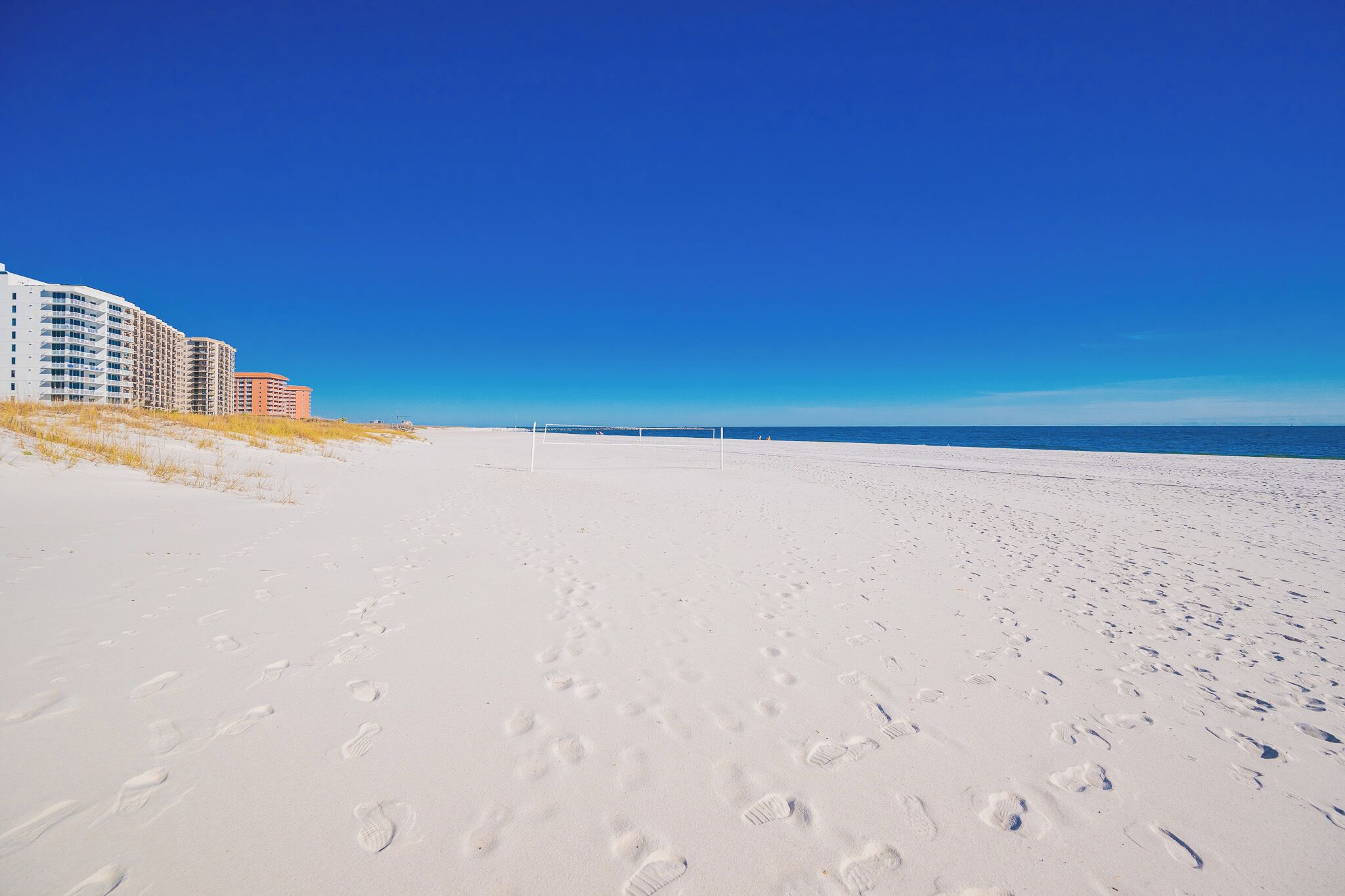 Stroll along the soft, white sands with stunning beachfront views and nearby volleyball courts for active fun on the beach