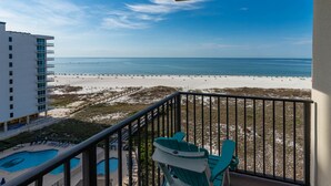 A balcony with a view of a beach and a pool. - Phoenix VII -7917 9th Floor - 3 Bedroom (Orange Beach)