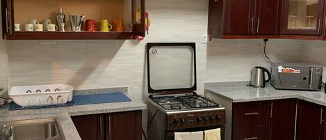 Microwave, coffee/tea maker, cookware/dishes/utensils