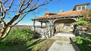 Traditional architecture with a curved roofline and arched walkway leading to the entrance.