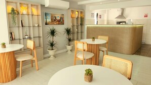 A modern hotel lobby with round tables, wicker chairs, potted plants, a reception desk, and a wall-mounted air conditioner. - Karden Otel (Antalya)