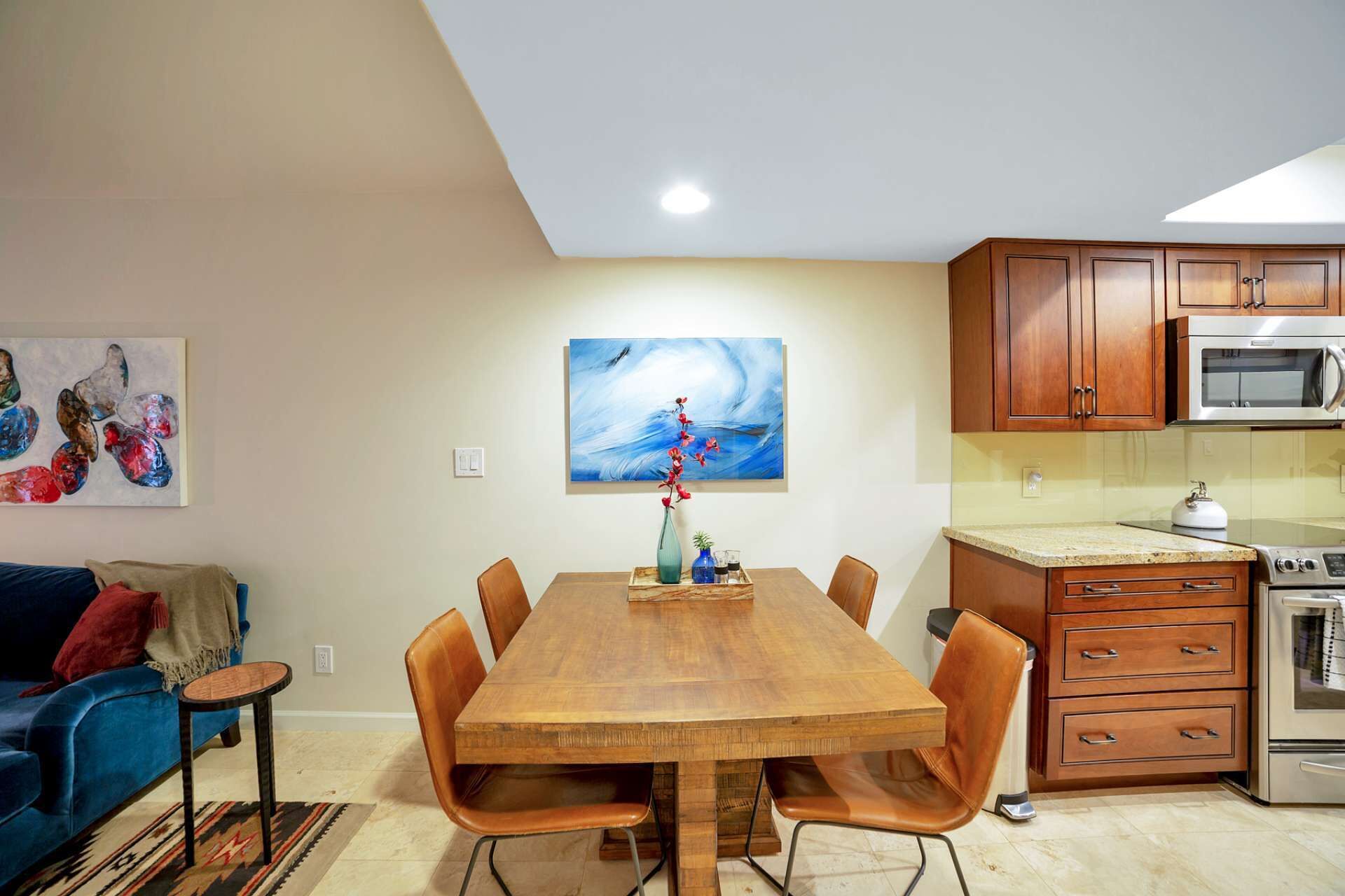 A modern kitchen with wooden cabinets, a microwave, and an oven.