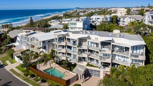 A modern multi-story hotel with balconies, a swimming pool, and ocean views. - Generous and Comfortable Beachside Abode - See the Ocean - All on one level, lift, pool (SUNSHINE BEACH)