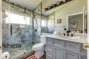 Bathtub, hair dryer, towels, shampoo