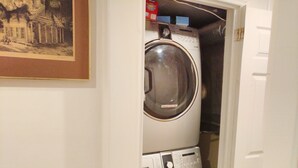 A laundry room with two stacked front-loading washing machines. - Toronto vacation home in North York with free parking (minimum 28 days stay)  (North York)