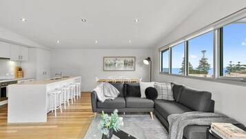 A modern living space with a kitchen, dining area, and seating area.