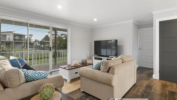 A modern living room with a sofa, coffee table, and TV. - Settle Inn, Settlement Rd holiday house, close to shops and beach! (Cowes)