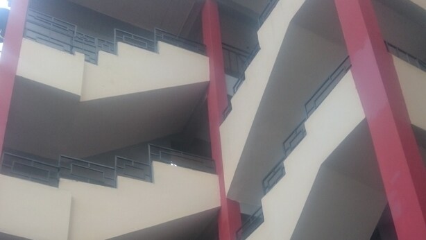A multi-level building with a staircase and railings.