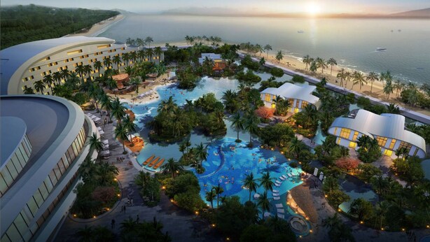 A resort with multiple swimming pools, palm trees, and beachfront views.