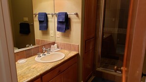 A bathroom with a sink, mirror, and shower. - Fair Oaks Ranch Deer Meadow Estates (Fair Oaks Ranch)
