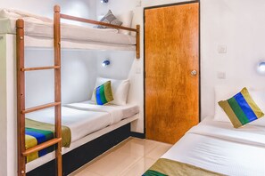 A bunk bed room with a wooden ladder, a door, and a single bed with a pillow. - Pinnawala Backpack Residencies (Rambukkana)