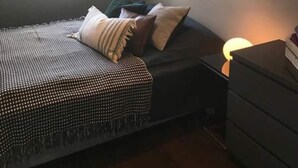 A bedroom with a bed, pillows, a dresser, and a window. - Private room in a shared, centrally located apartment (St. Hanshaugen)