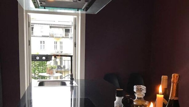 A modern kitchen with a glass top table, a plate of fruit, candles, and a bottle of salt. - Private room in a shared, centrally located apartment (St. Hanshaugen)
