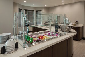 A buffet area with a variety of food options, including fruits, nuts, and chocolate desserts. - Staybridge Suites Phoenix - Biltmore Area by IHG (Phoenix)