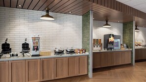 A modern kitchen area with a brick wall, wooden cabinets, and a coffee machine. - Fairfield Inn & Suites by Marriott Milwaukee West (Milwaukee)