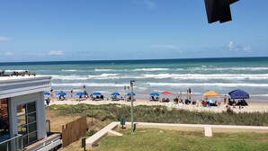 A beach with umbrellas and people. - New Listing! Beachside gem, newly remodeled & redecorated  (South Padre Island)