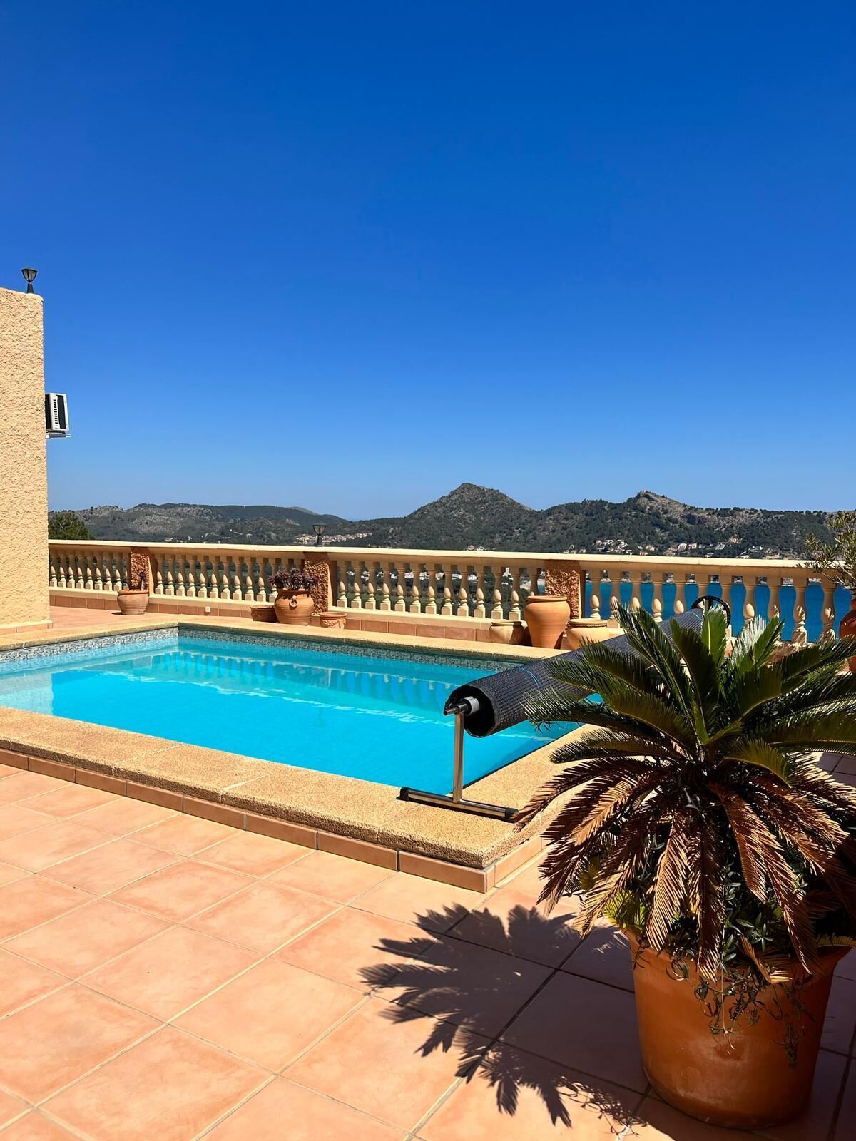 A rooftop pool with a clear view of the surrounding landscape.