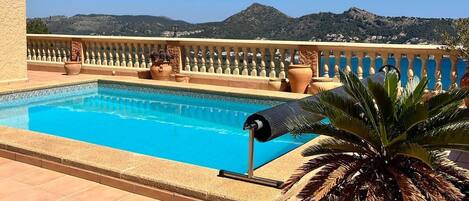 A rooftop pool with a clear view of the surrounding landscape.