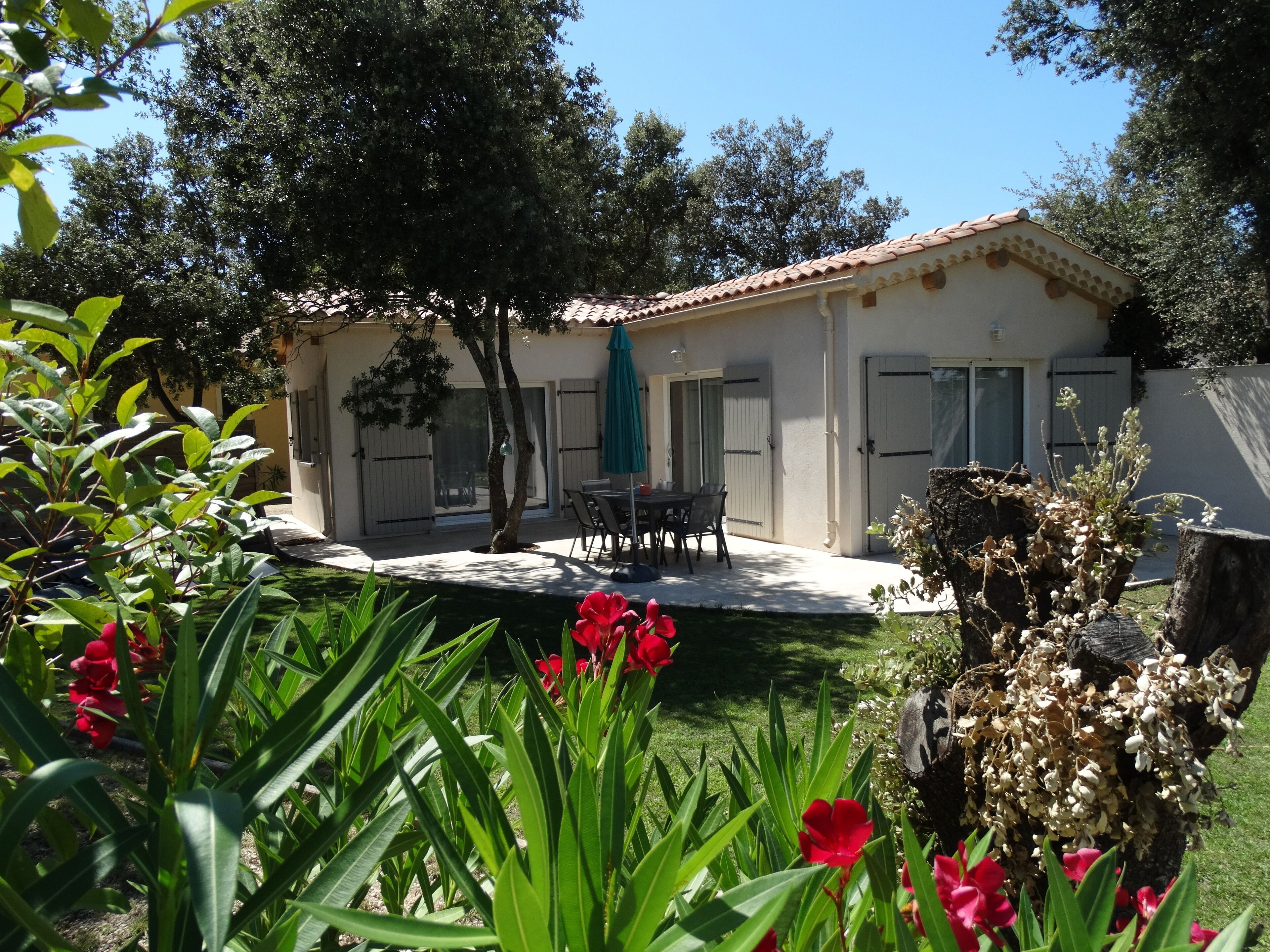 A house with a patio, a table, and chairs.