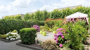 Stroll through the serene garden, surrounded by vibrant hydrangeas and roses, and relax beneath the gazebo.