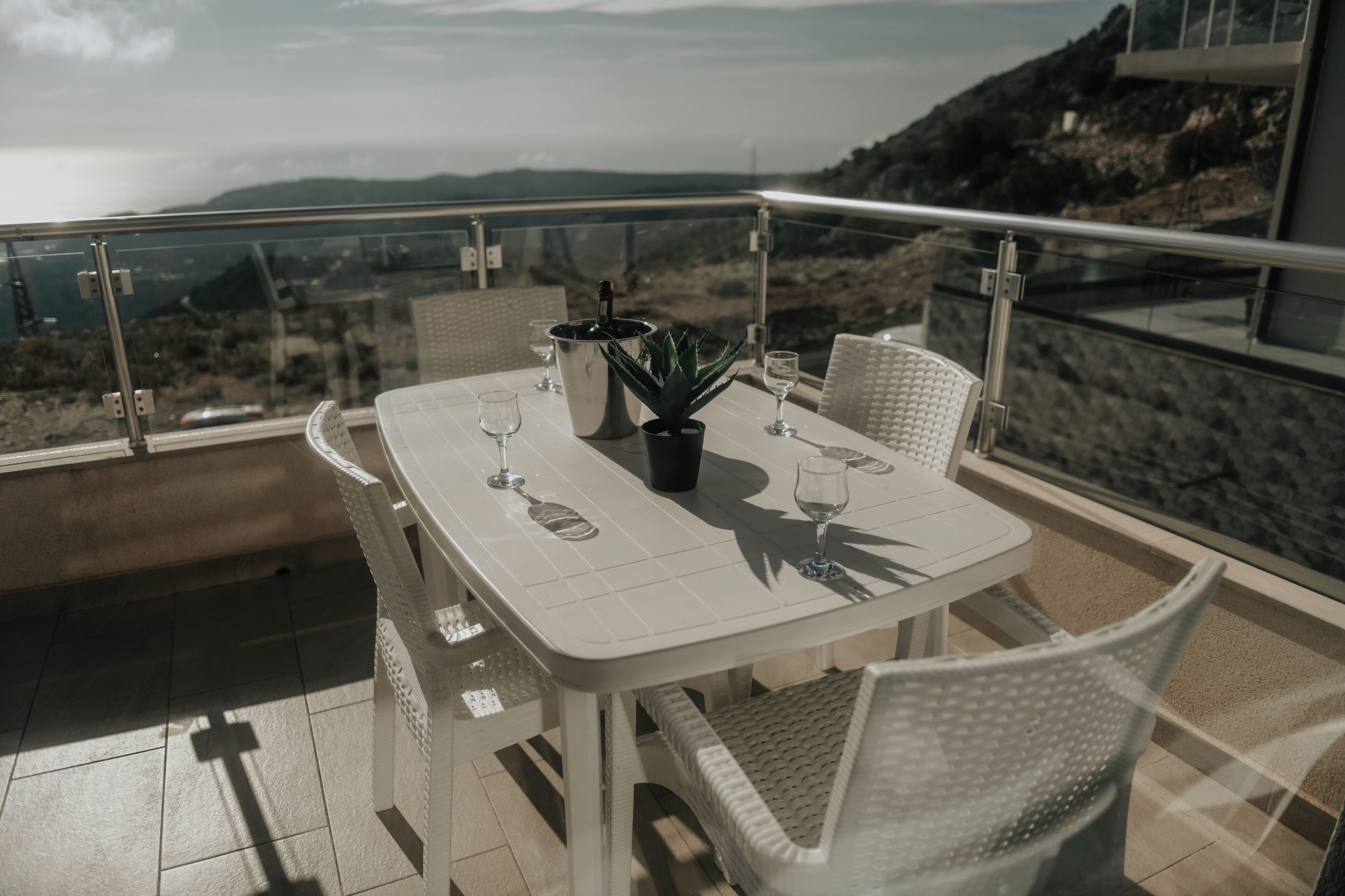 A table set for two with a view of the landscape.