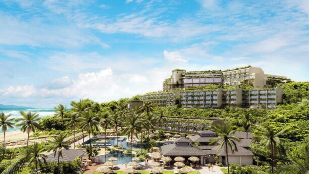 A resort with a pool area, palm trees, and a large building with multiple balconies overlooking the ocean. - Tropical & Elegant- Sleeps 8- Ocean/Waterfall Views (Princeville)