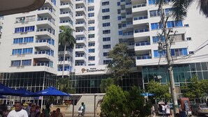 A multi-story building with balconies, a sign reading "Nuevo Conquistador," and a modern glass facade. - Across from the Beach Edificio El Nuevo Conquistador Apto 612 Barrio El Laguito (Cartagena)