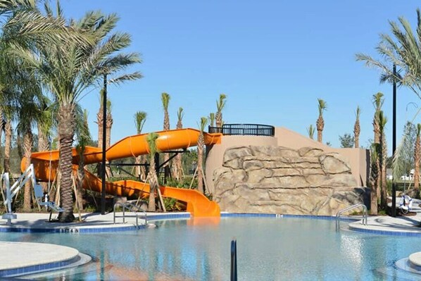Relax by the pool surrounded by palm trees and enjoy a thrilling water slide experience.