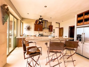 Enjoy cooking in this well-equipped kitchen with a central island, sink, and stove.