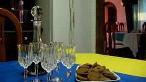 A dining table with a blue tablecloth, a plate of cookies, and several crystal glasses. - Villa de Sao Paulo - (Funchal)