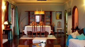 A cozy living room with a dining table, chairs, a sofa, and a coffee table. - Villa de Sao Paulo - (Funchal)