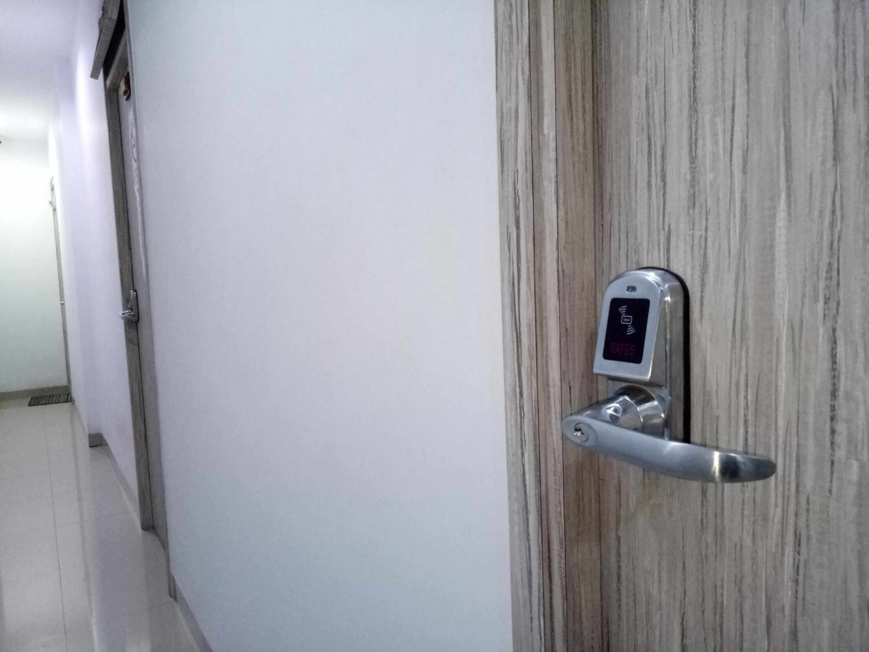 A door with a modern electronic lock and a keyhole.