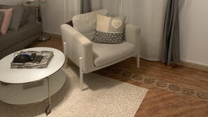 A living room with a sofa, a chair, a coffee table, and a floor lamp. - Apartment very close to Gran Via Sol WiFi Museums  (Madrid)