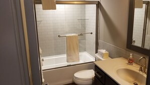 A bathroom with a bathtub, toilet, and sink. - Beautiful 3 Bed , 3 Bath with Great Location! Renovated in 2025!  (Boyne Falls)