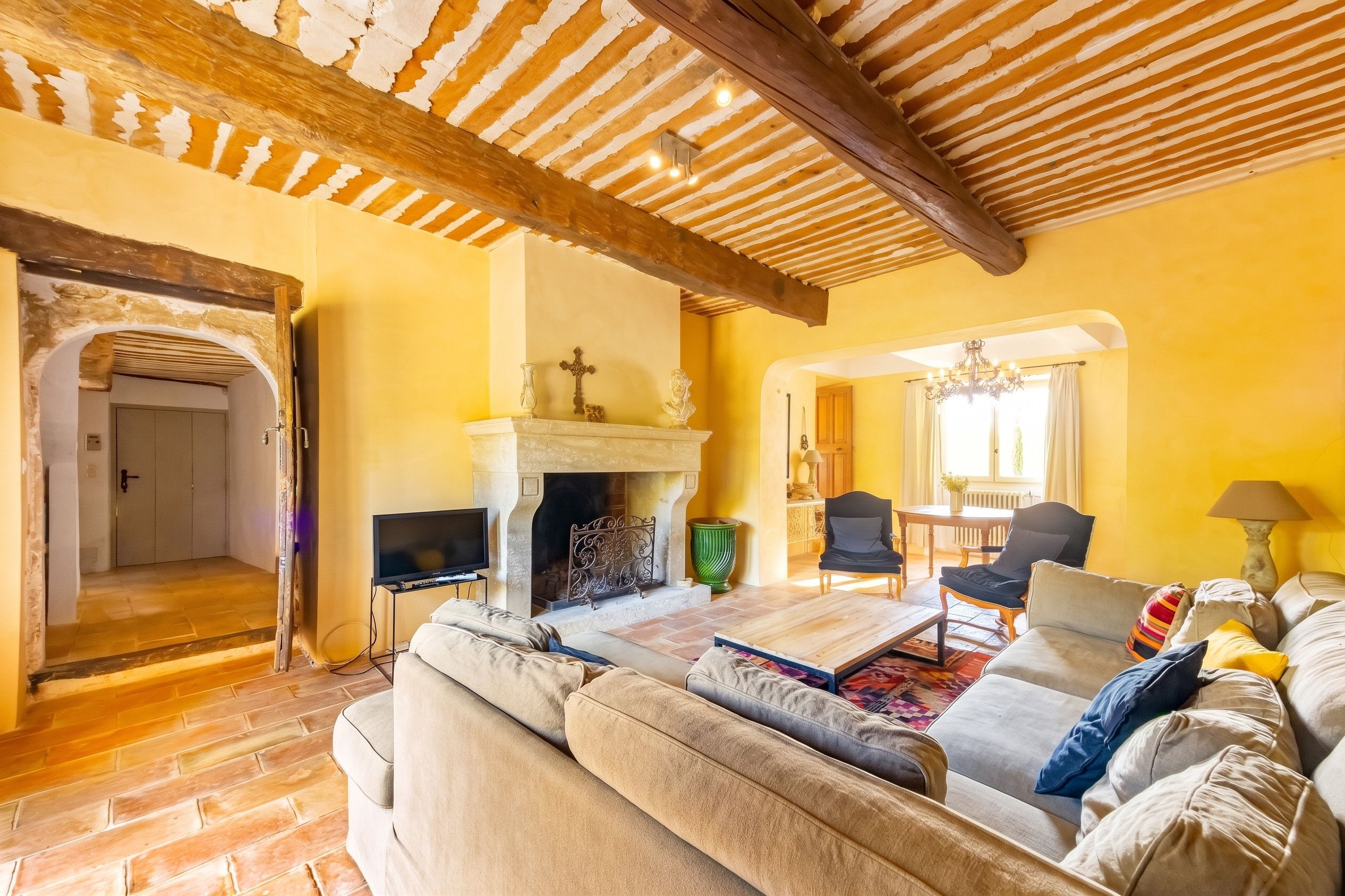 A living room with a fireplace, a television, and a sofa.