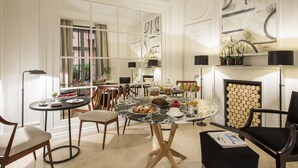 A dining area with a round table, chairs, and a buffet setup. - Residenza B (Rome)