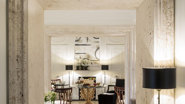 A spacious living area with a large mirror, a floor lamp, and a dining table with chairs. - Residenza B (Rome)