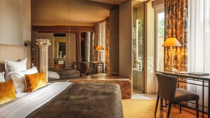 A hotel room with a bed, a desk, a chair, and a view of the outdoors.