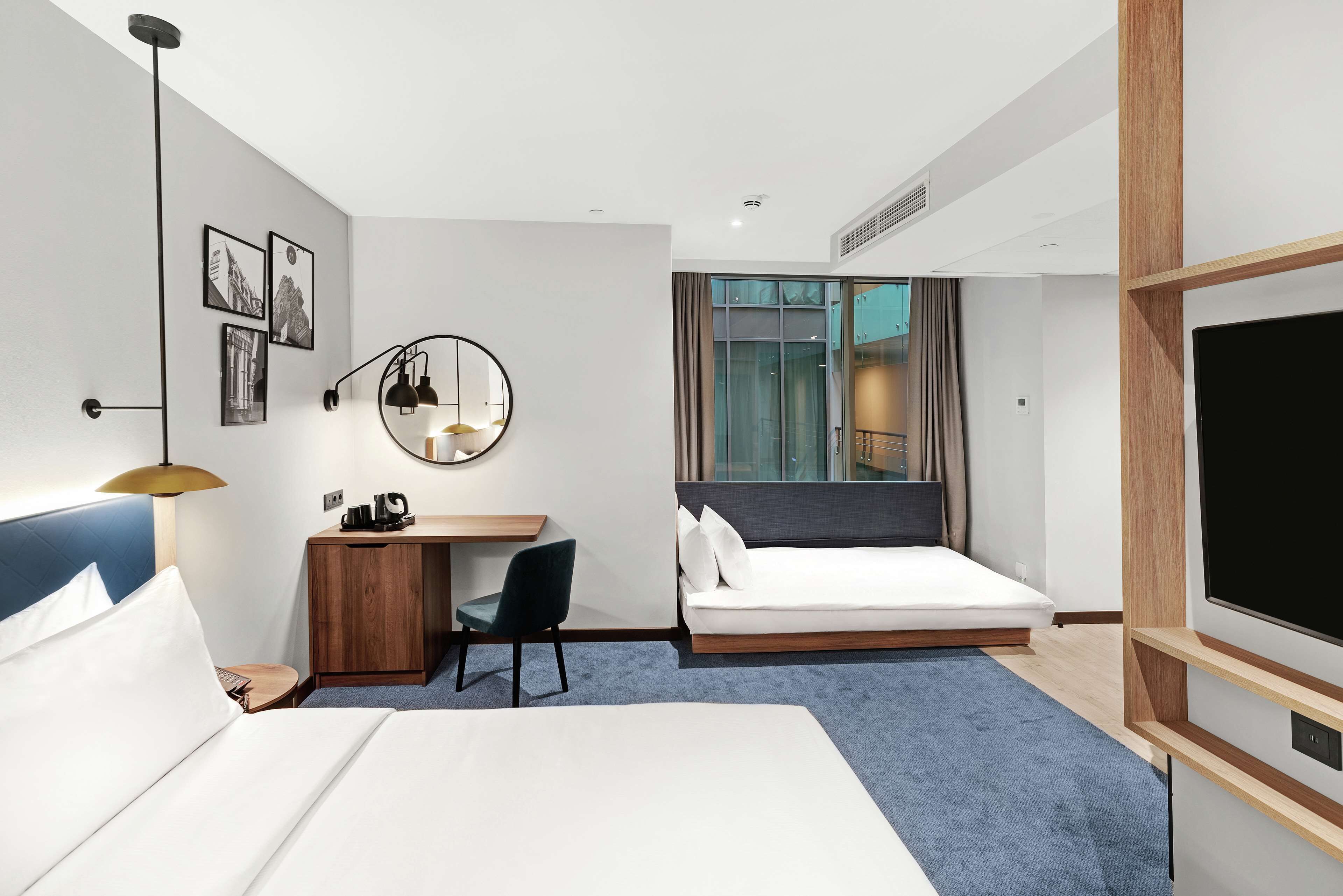 family room, 1 king bed with sofa bed (atrium view) | in-room safe, desk, laptop workspace, blackout curtains