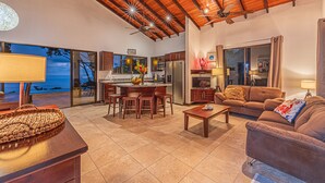 A spacious living area with a kitchen, dining table, and seating.